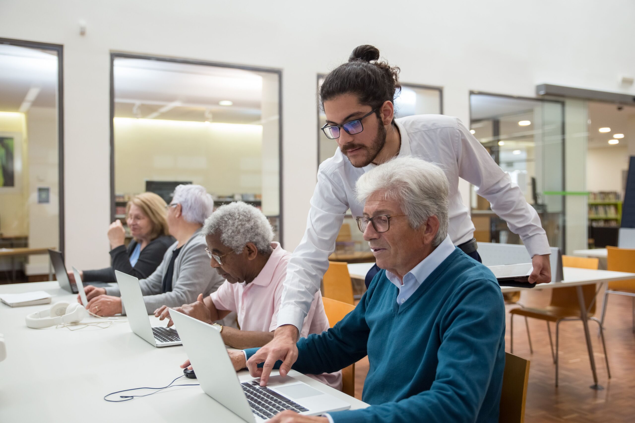 gentleman supporting elderly man using the computor