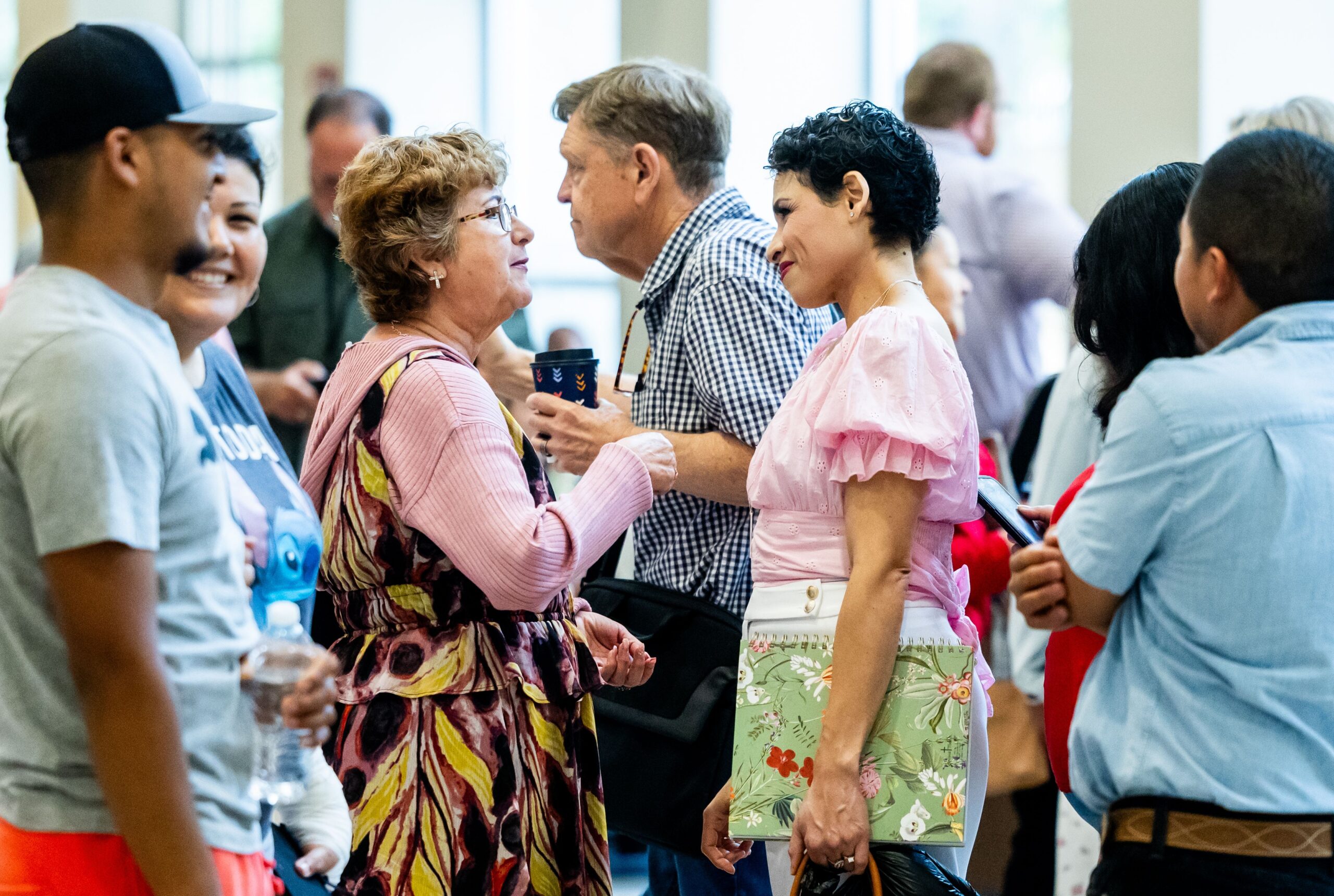 lading talking to each other in a crowded community event